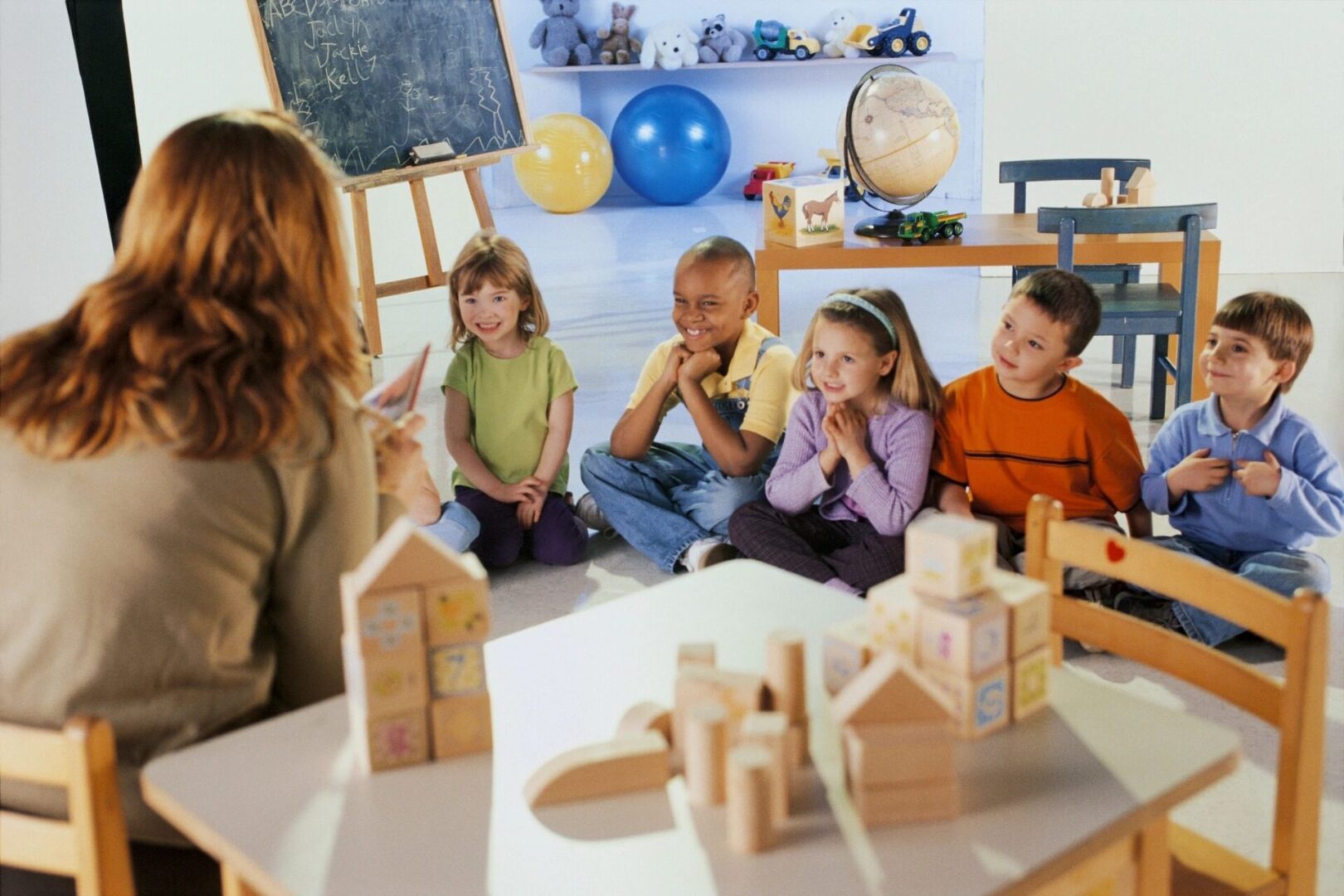 A group of children sitting around a table.